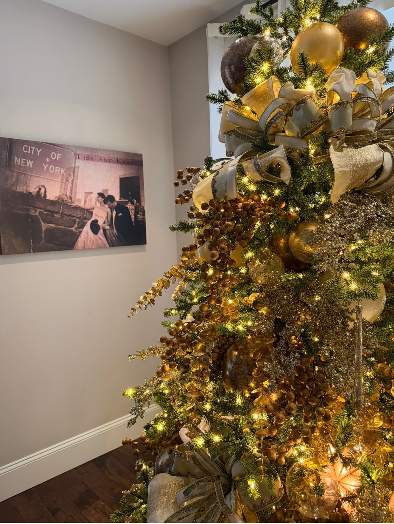 Elegant gold and champagne Christmas tree — room view with wedding photo